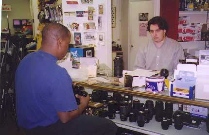 Byron Albert demonstrates Nikon camera for a customer